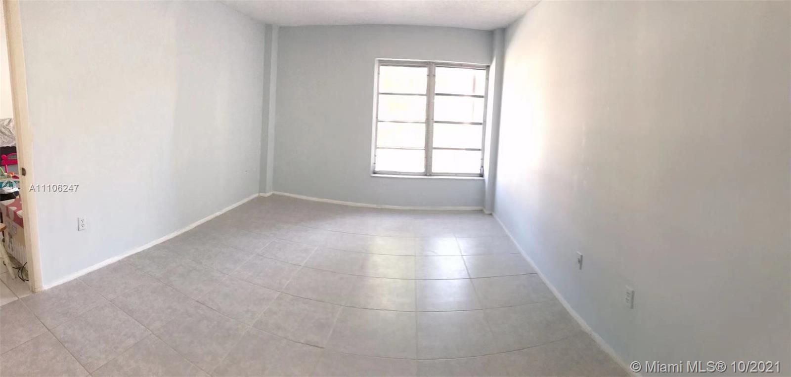 4172 Inverrary Drive, Unit 304 Lauderhill, FL 33319 - Photo 4 of 13 an empty room with windows and entrance