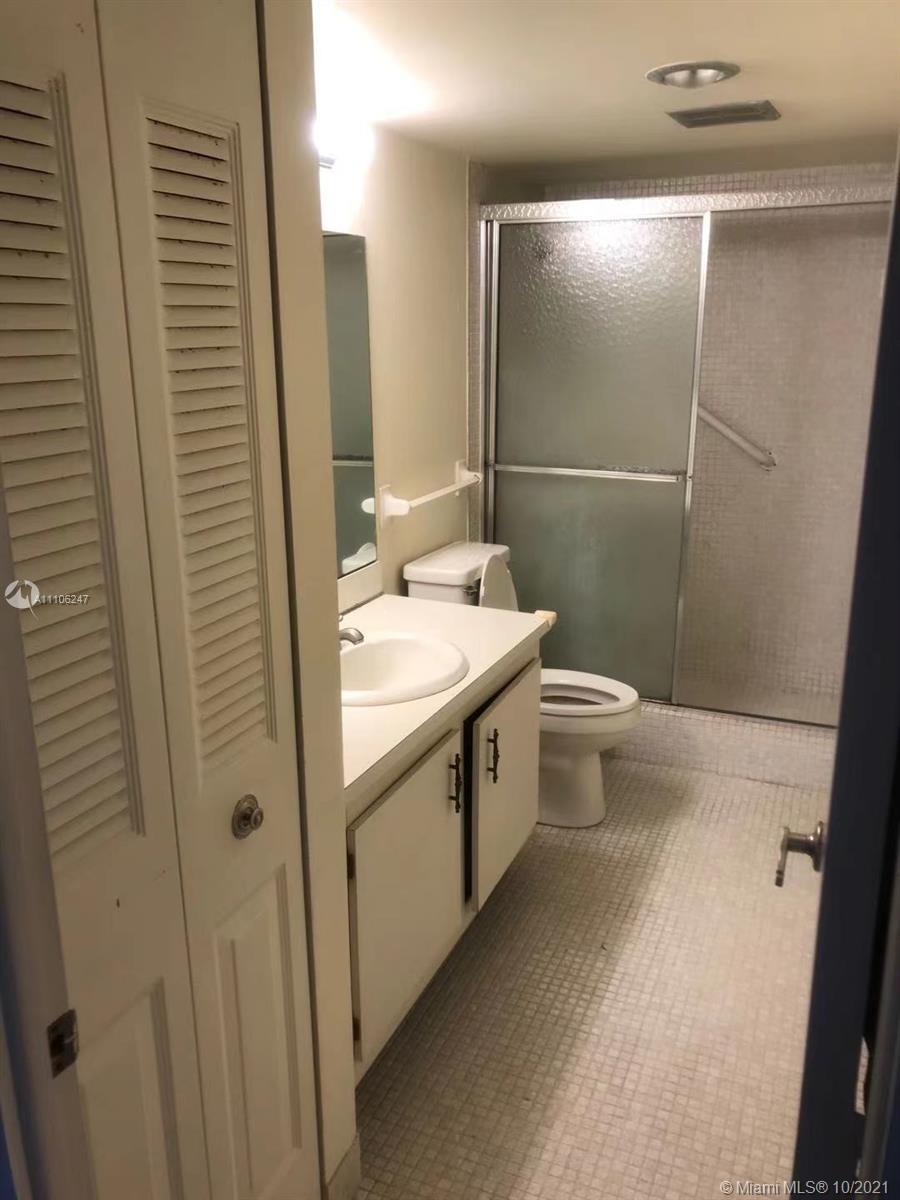 4172 Inverrary Drive, Unit 304 Lauderhill, FL 33319 - Photo 6 of 13 a bathroom with a sink a toilet and shower