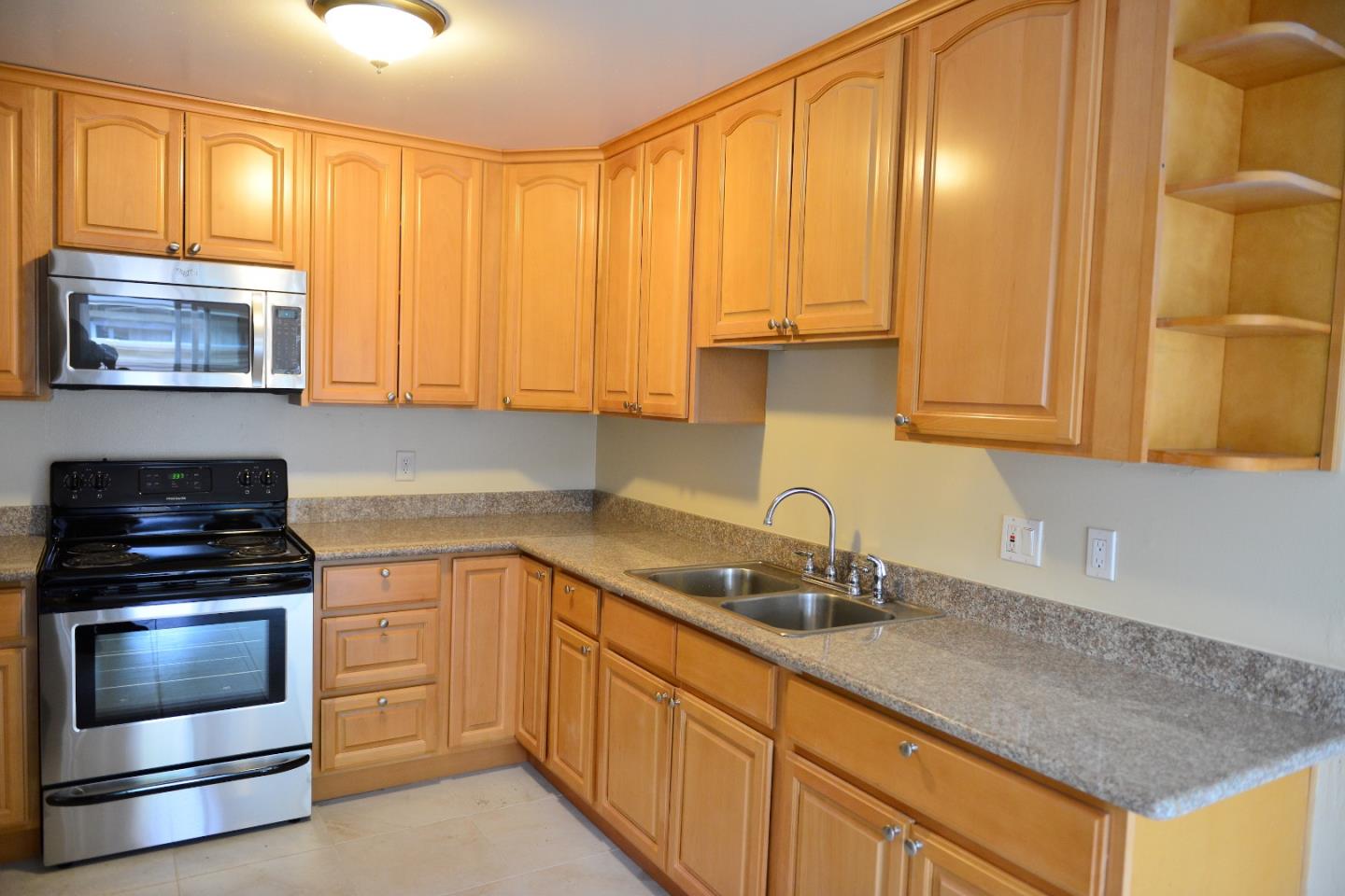 3817 Starview Drive San Jose, CA 95124 - Photo 7 of 15 a kitchen with granite countertop a sink a stove and cabinets