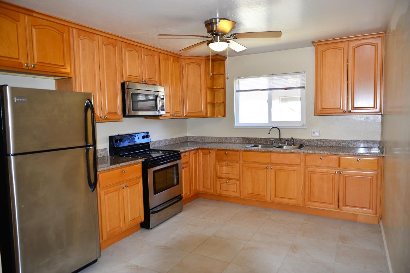3817 Starview Drive San Jose, CA 95124 - Photo 8 of 15 a kitchen with stainless steel appliances granite countertop a refrigerator a stove a sink and a window