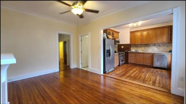 a view of a kitchen counter space wooden floor and staircase