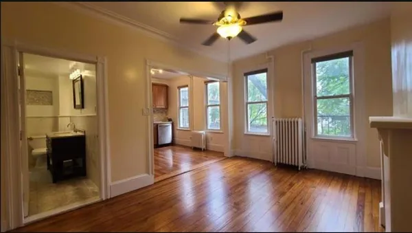 a view of an entryway with wooden floor and a ceiling fan