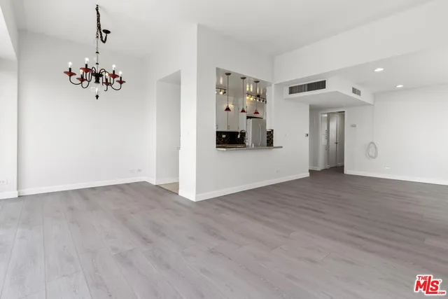 a view of a dining room with furniture wooden floor and a flat screen tv