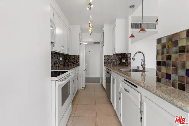 a kitchen with stainless steel appliances granite countertop a sink and cabinets