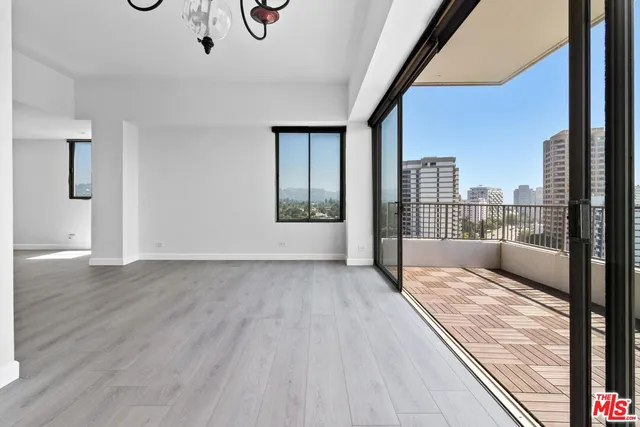 a view of an empty room and wooden floor