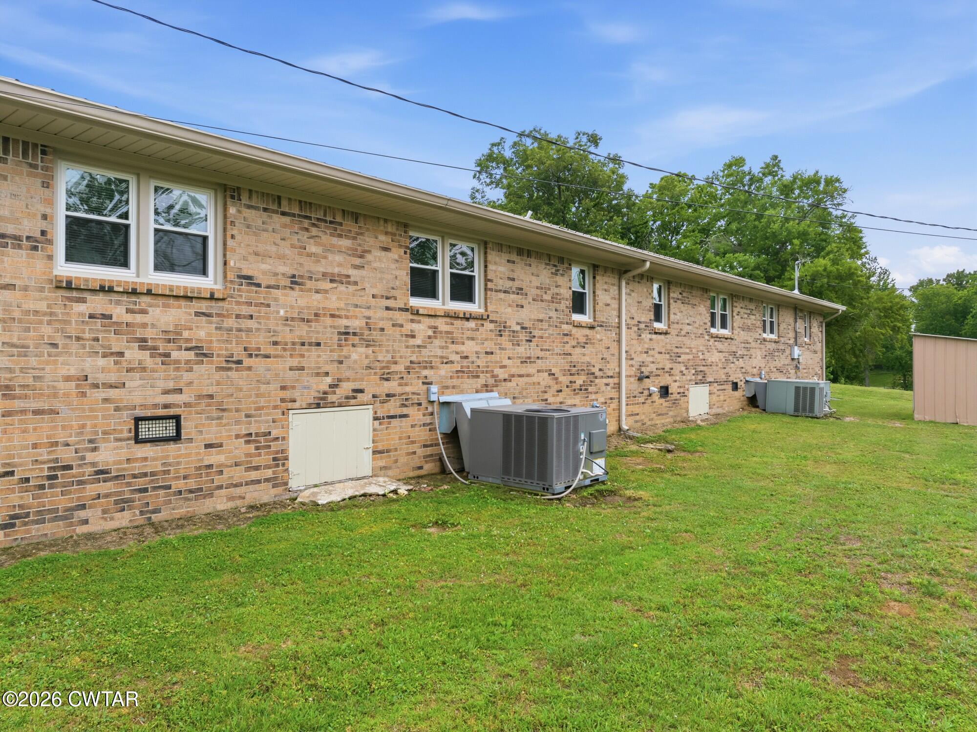 944 Brooksie Thompson Road Decaturville, TN 38329 - Photo 37 of 47 a view of a house with backyard and a garden