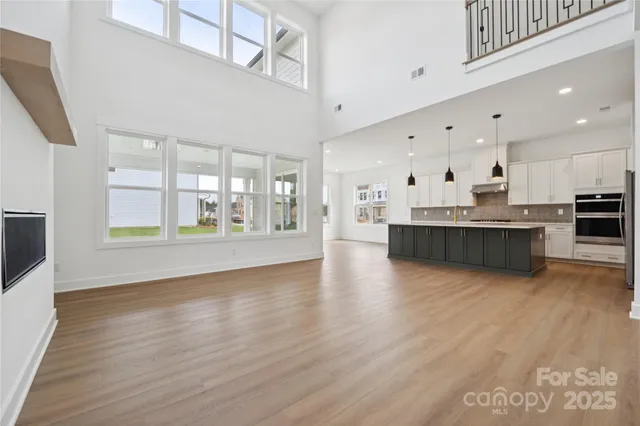 a big room with wooden floor and windows
