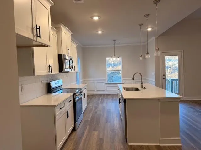 a kitchen with a sink and a mirror