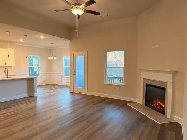 a kitchen with stainless steel appliances granite countertop a refrigerator a sink dishwasher and a oven with wooden floor