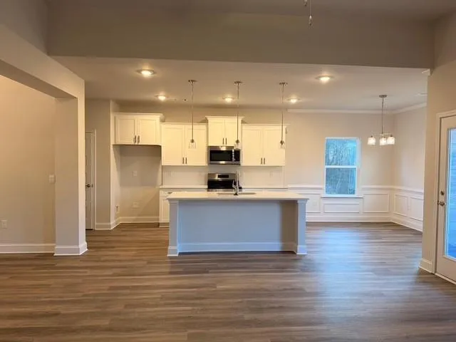 a view of a kitchen with a dishwasher cabinets and a wooden floor