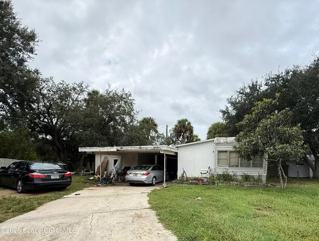 a view of a house with a yard and sitting area