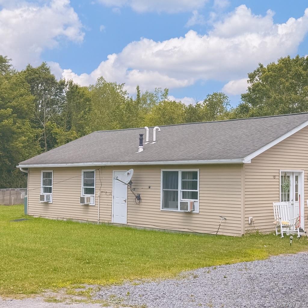 105-107 East Cold Spring Road Monticello, NY 12701 - Photo 11 of 22 Single story home featuring a shingled roof and a front lawn