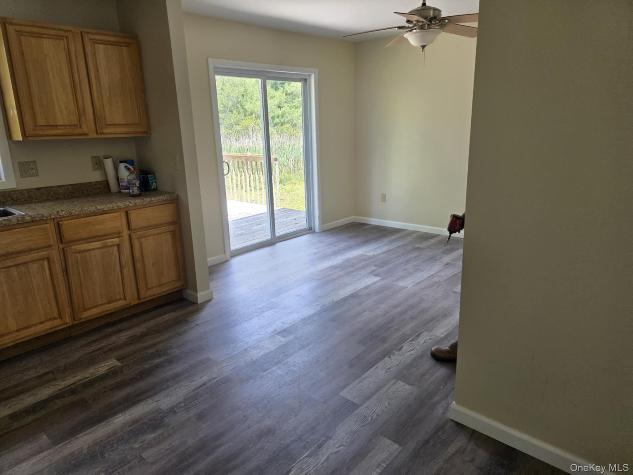 105-107 East Cold Spring Road Monticello, NY 12701 - Photo 14 of 22 Unfurnished dining area with ceiling fan and dark wood-style floors