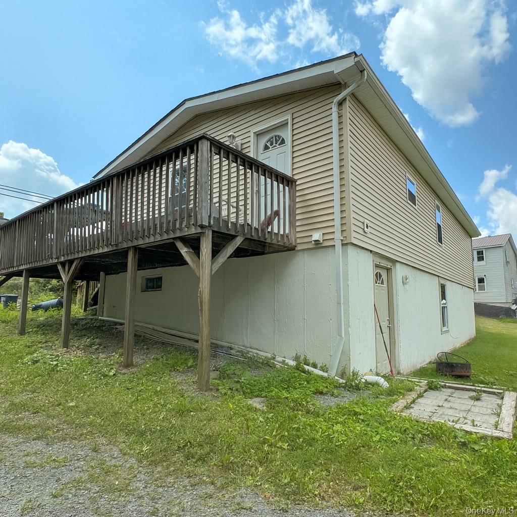 105-107 East Cold Spring Road Monticello, NY 12701 - Photo 2 of 22 View of property exterior with a deck and a yard