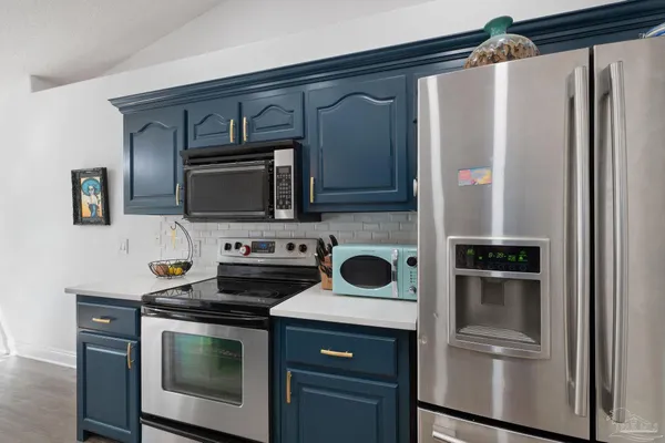 a kitchen with a refrigerator stove and microwave