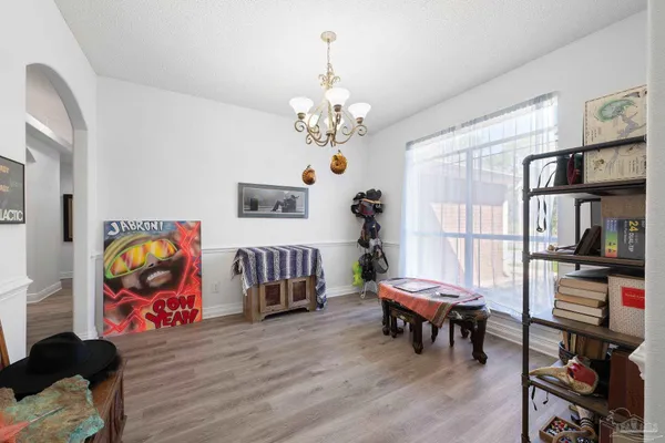 a living room with furniture and paintings on the wall