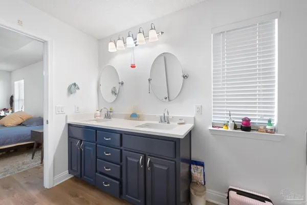 a bathroom with a double vanity sink and a mirror