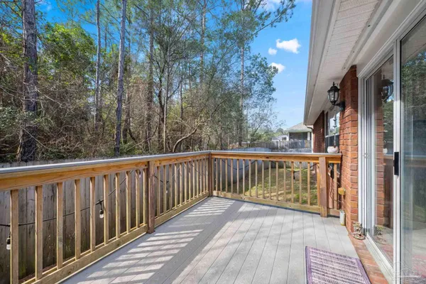 a view of a balcony with wooden floor and fence