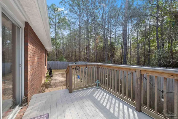 a view of balcony with wooden floor and seating space
