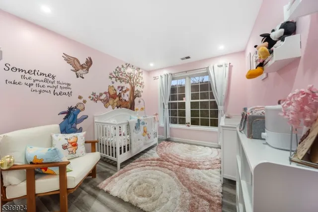 a bedroom with furniture and a large window