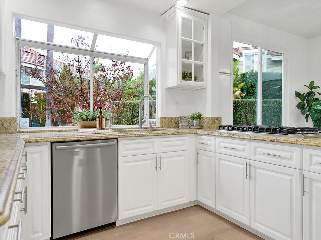 13814 Apache Tustin, CA 92782 - Photo 12 of 45 a kitchen with white cabinets and a large window