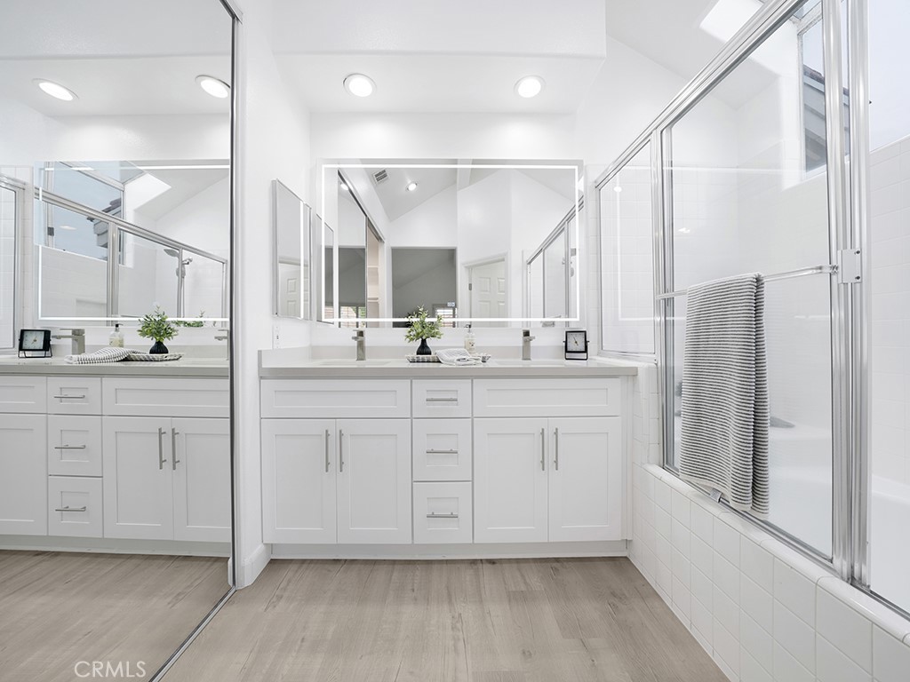 13814 Apache Tustin, CA 92782 - Photo 22 of 45 a bathroom with a double vanity sink a mirror and a shower