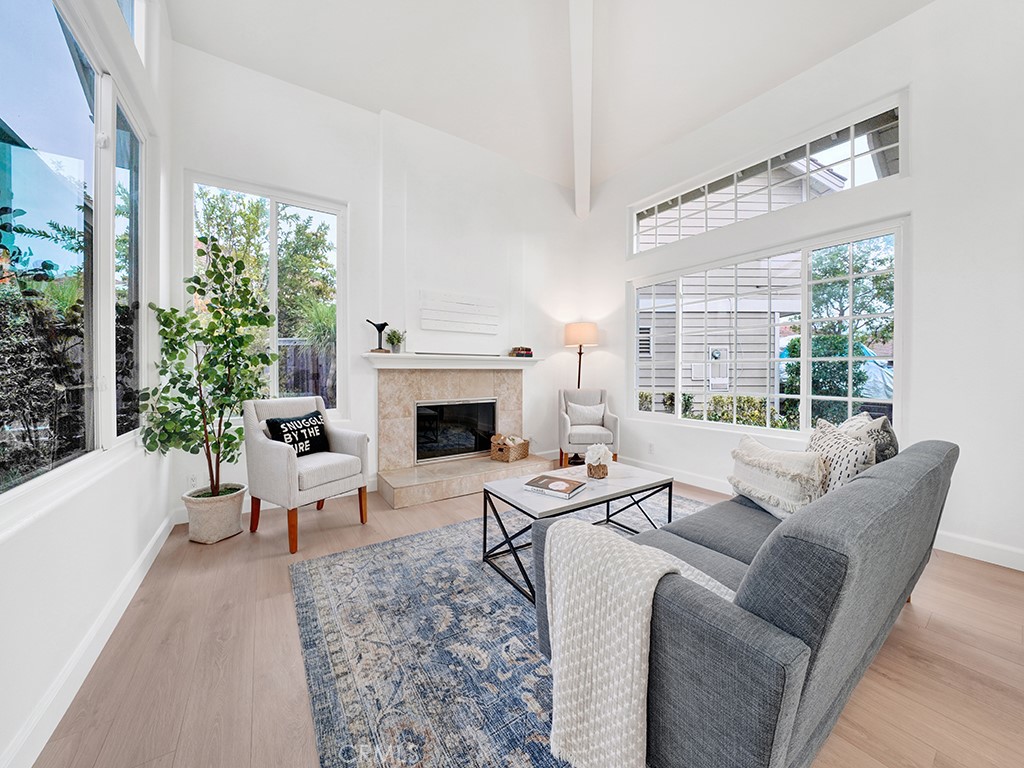 13814 Apache Tustin, CA 92782 - Photo 3 of 45 a living room with furniture a large window and a fireplace
