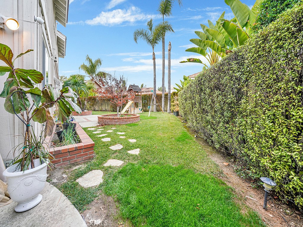 13814 Apache Tustin, CA 92782 - Photo 31 of 45 a view of a yard with plants and a bench