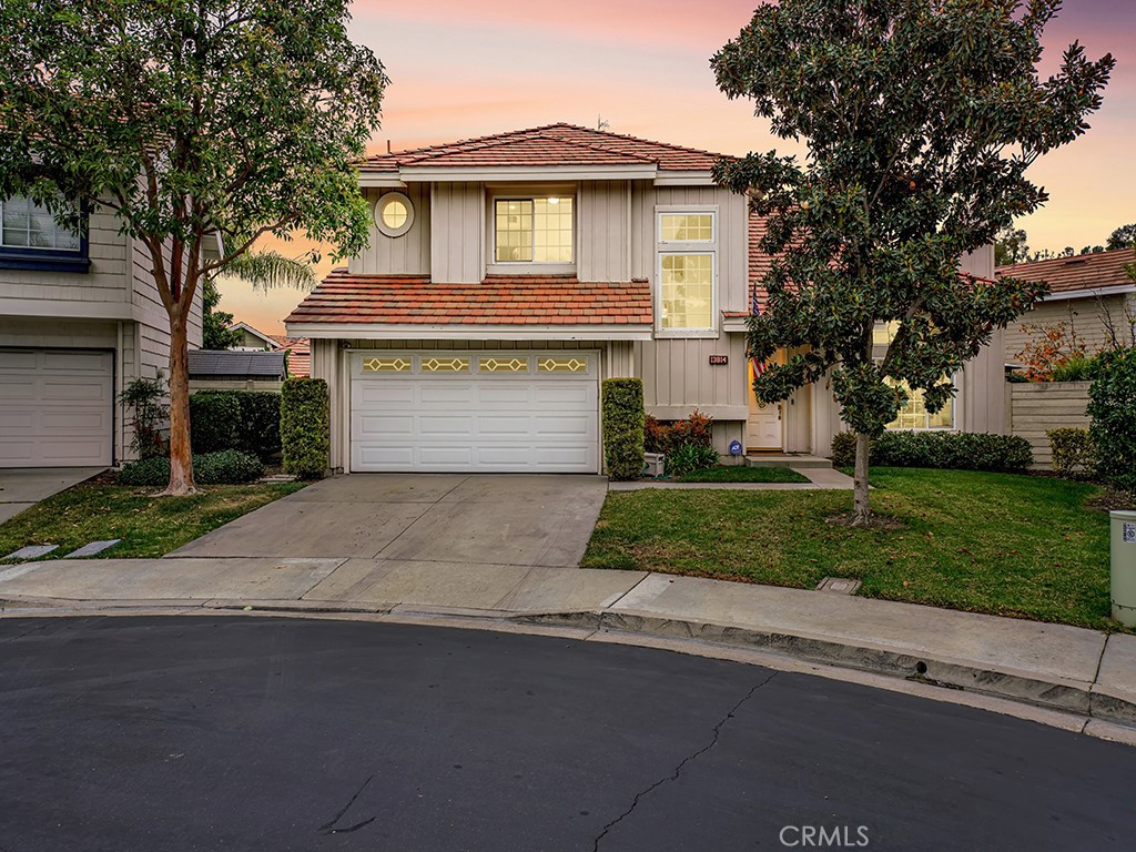 13814 Apache Tustin, CA 92782 - Photo 38 of 45 a front view of a house with a garden and yard
