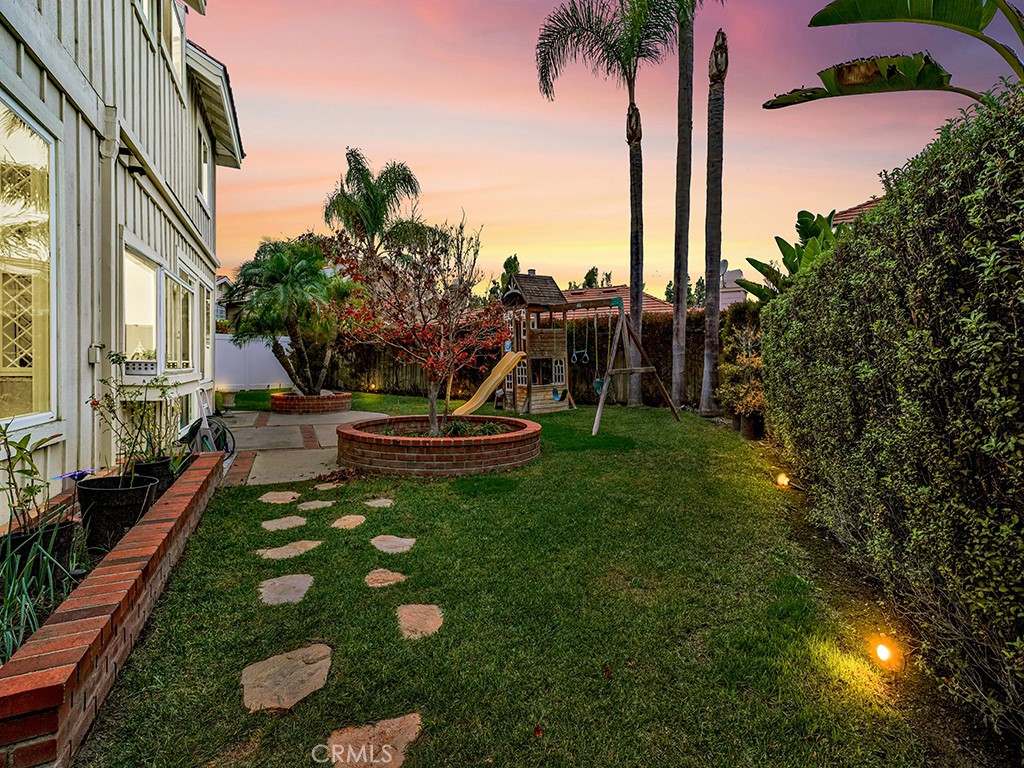 13814 Apache Tustin, CA 92782 - Photo 42 of 45 a view of a backyard with plants and palm tree