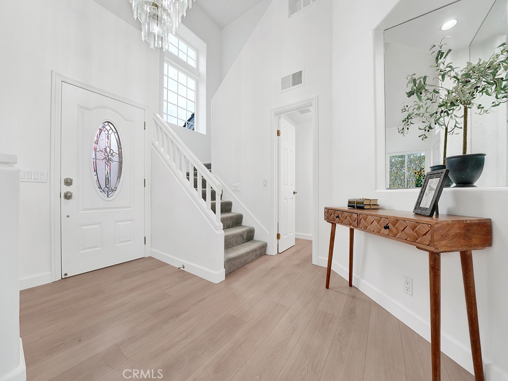 13814 Apache Tustin, CA 92782 - Photo 5 of 45 a view of entryway with a table and a chandelier