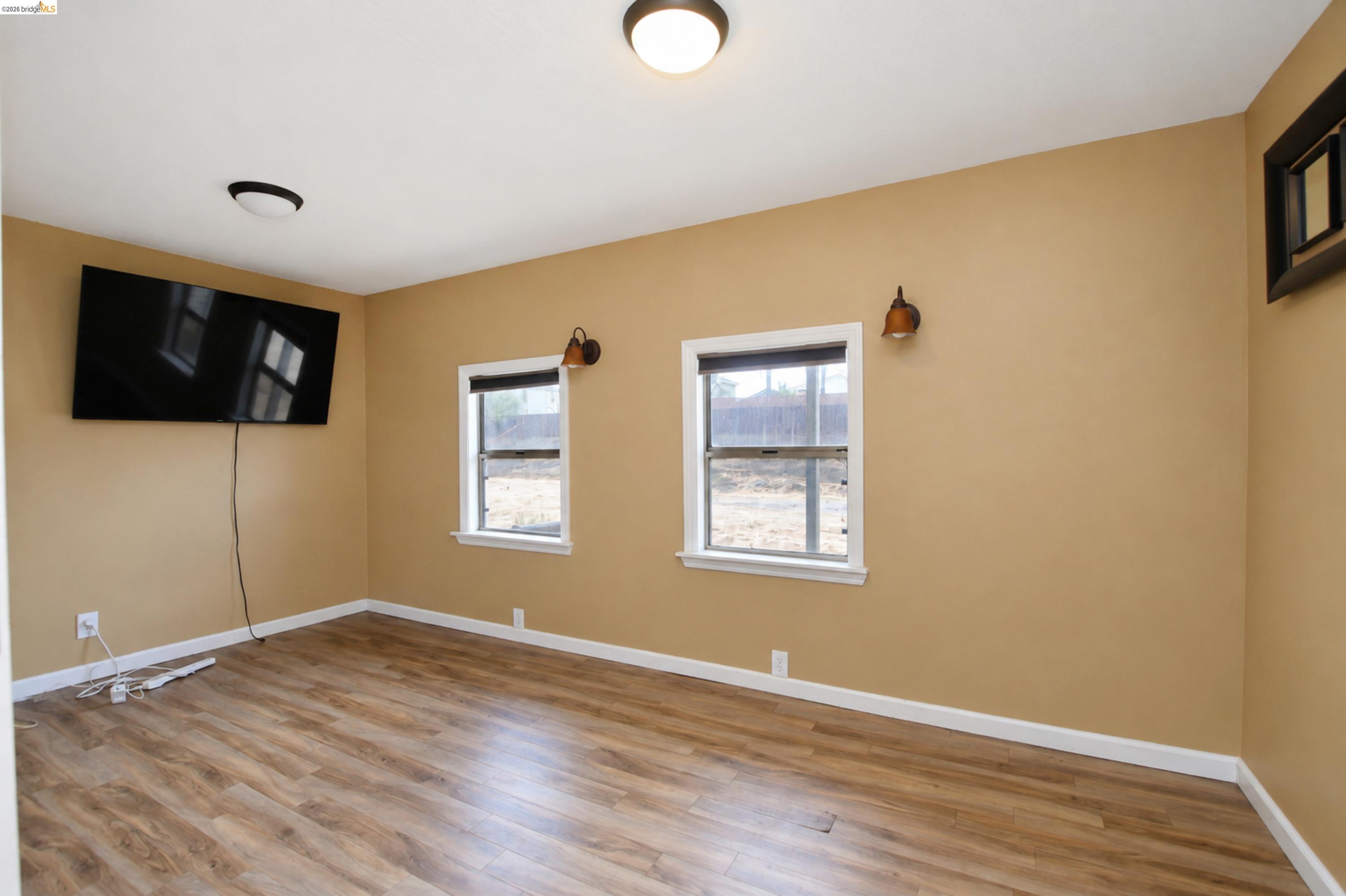 340 West Bolton Road Oakley, CA 94561 - Photo 79 of 87 Wood-finish flooring with white trim, two windows with blinds, and flush-mount ceiling lights