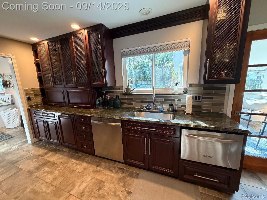 1615 Ladd Road Walled Lake, MI 48390 - Photo 10 of 28 Rich wood-finish cabinetry, stainless steel appliances, and a polished stone countertop