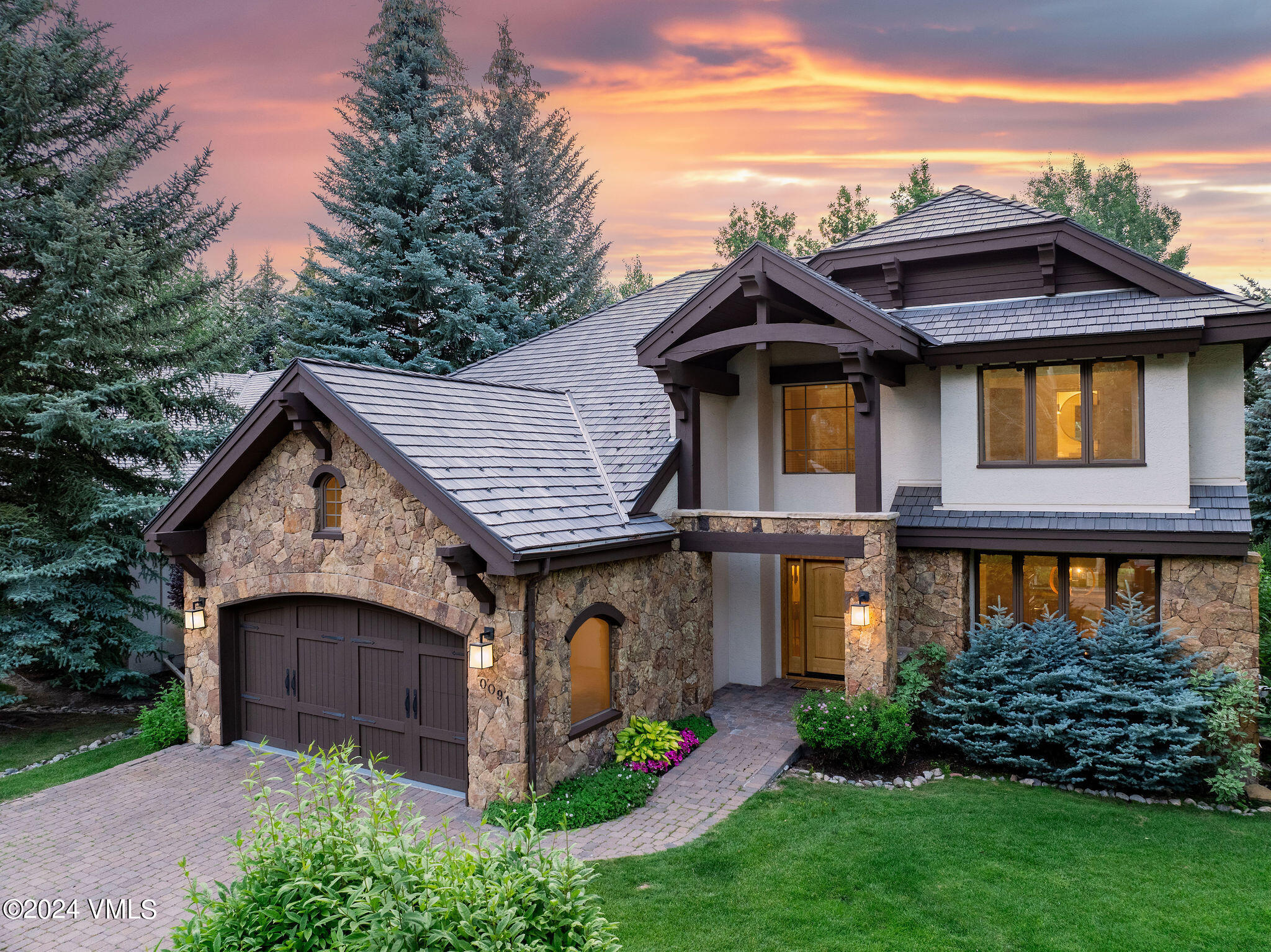91 Ambleside Place Edwards, CO 81632 - Photo 1 of 28 a front view of a house with a garden and plants
