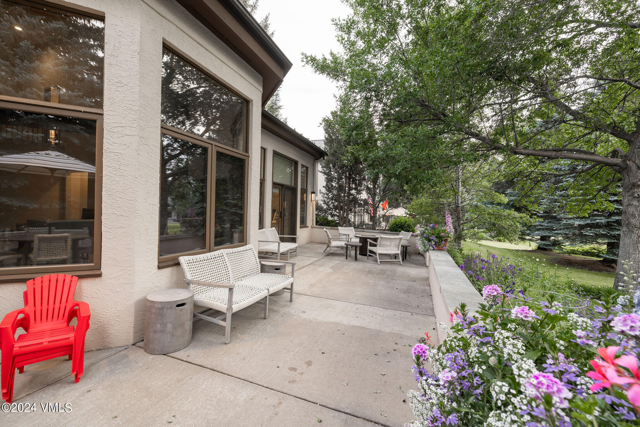 91 Ambleside Place Edwards, CO 81632 - Photo 24 of 28 a view of a patio with couches and table and chairs and potted plants