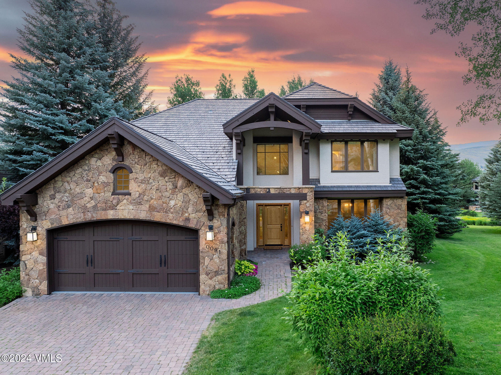 91 Ambleside Place Edwards, CO 81632 - Photo 25 of 28 a front view of a house with a garden and trees