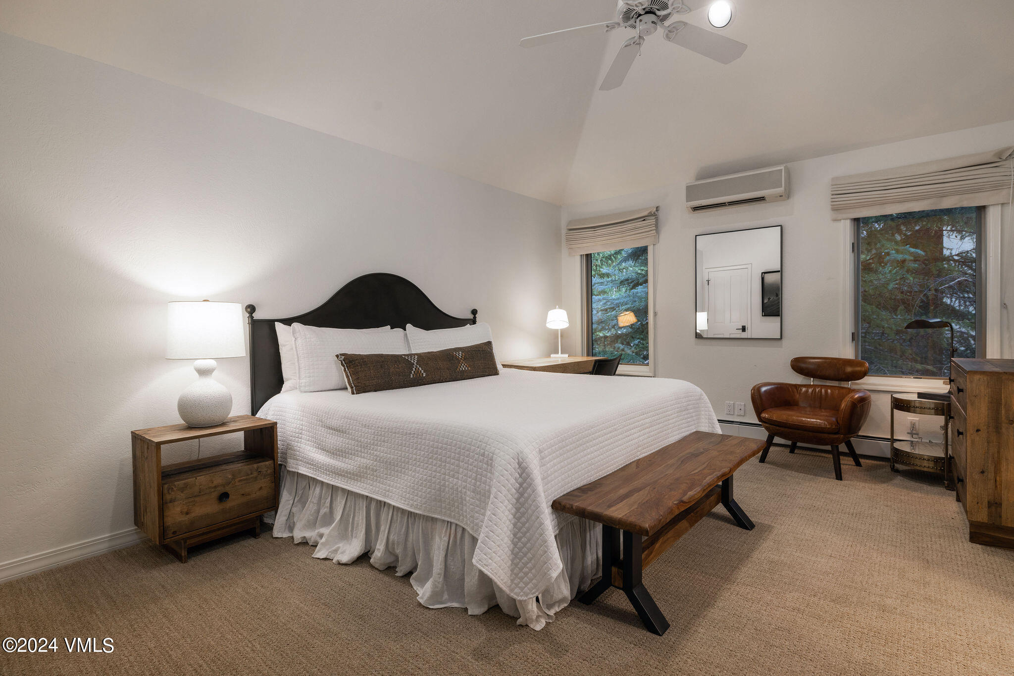 91 Ambleside Place Edwards, CO 81632 - Photo 10 of 28 a bedroom with a bed table chair and a chandelier