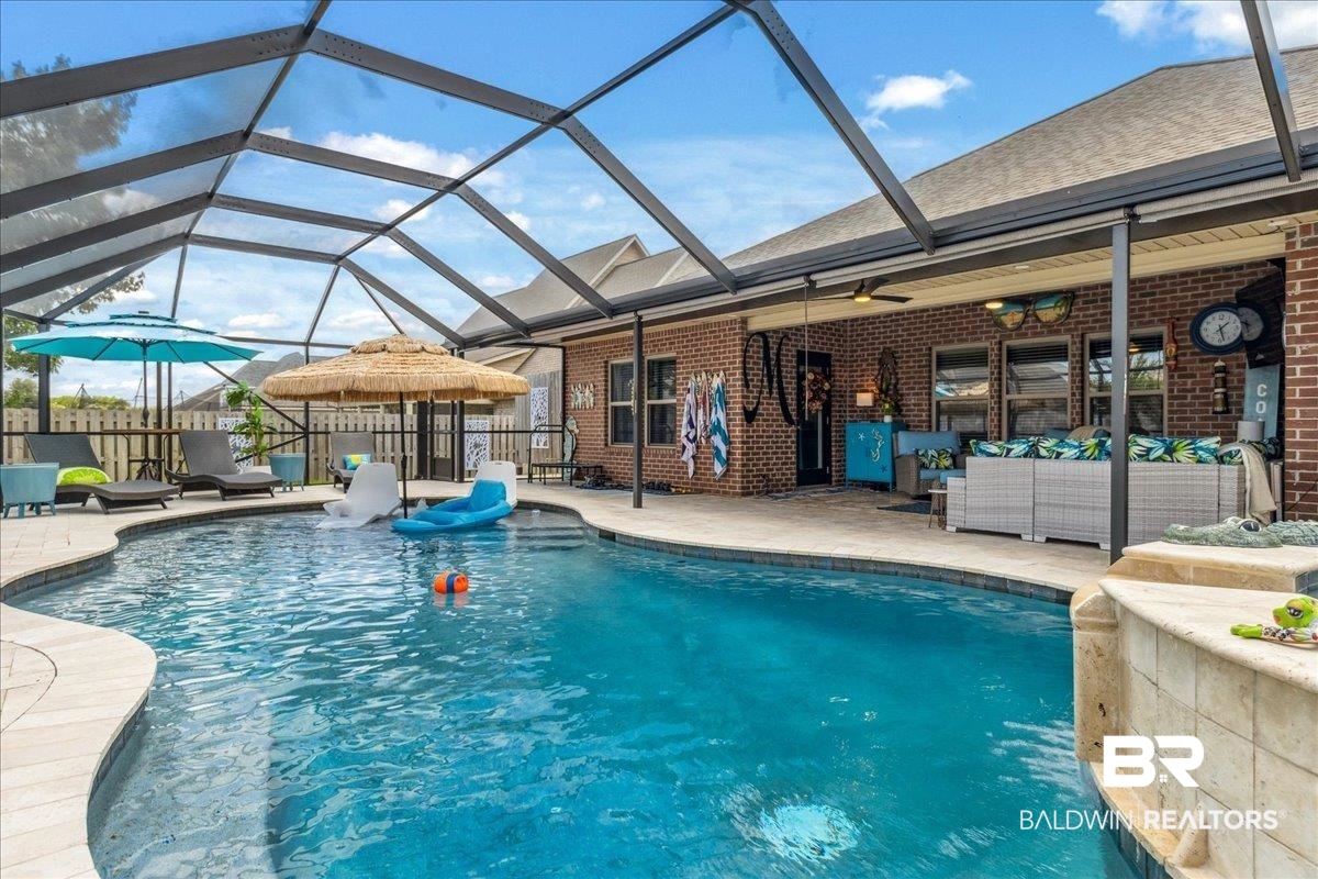 7022 Rocky Rd Loop Gulf Shores, AL 36542 - Photo 3 of 59 View of swimming pool featuring an outdoor living space, a patio area, and a lanai