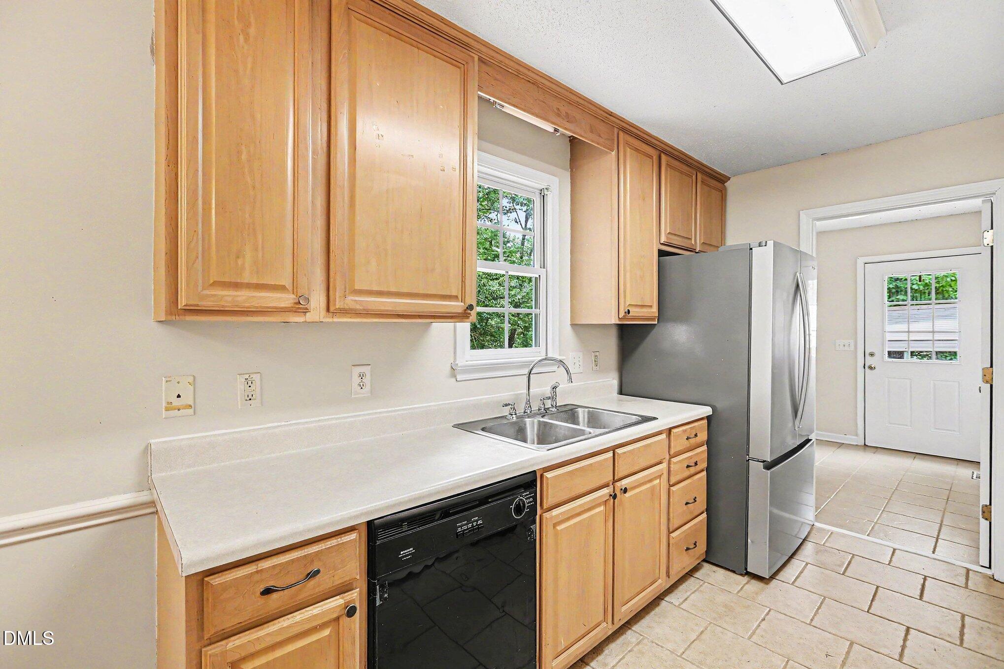 5359 Bass Mountain Road Snow Camp, NC 27349 - Photo 6 of 25 a kitchen with a sink cabinets and refrigerator