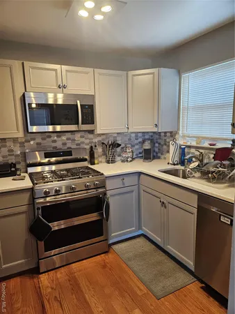 a kitchen with a stove a sink and a microwave