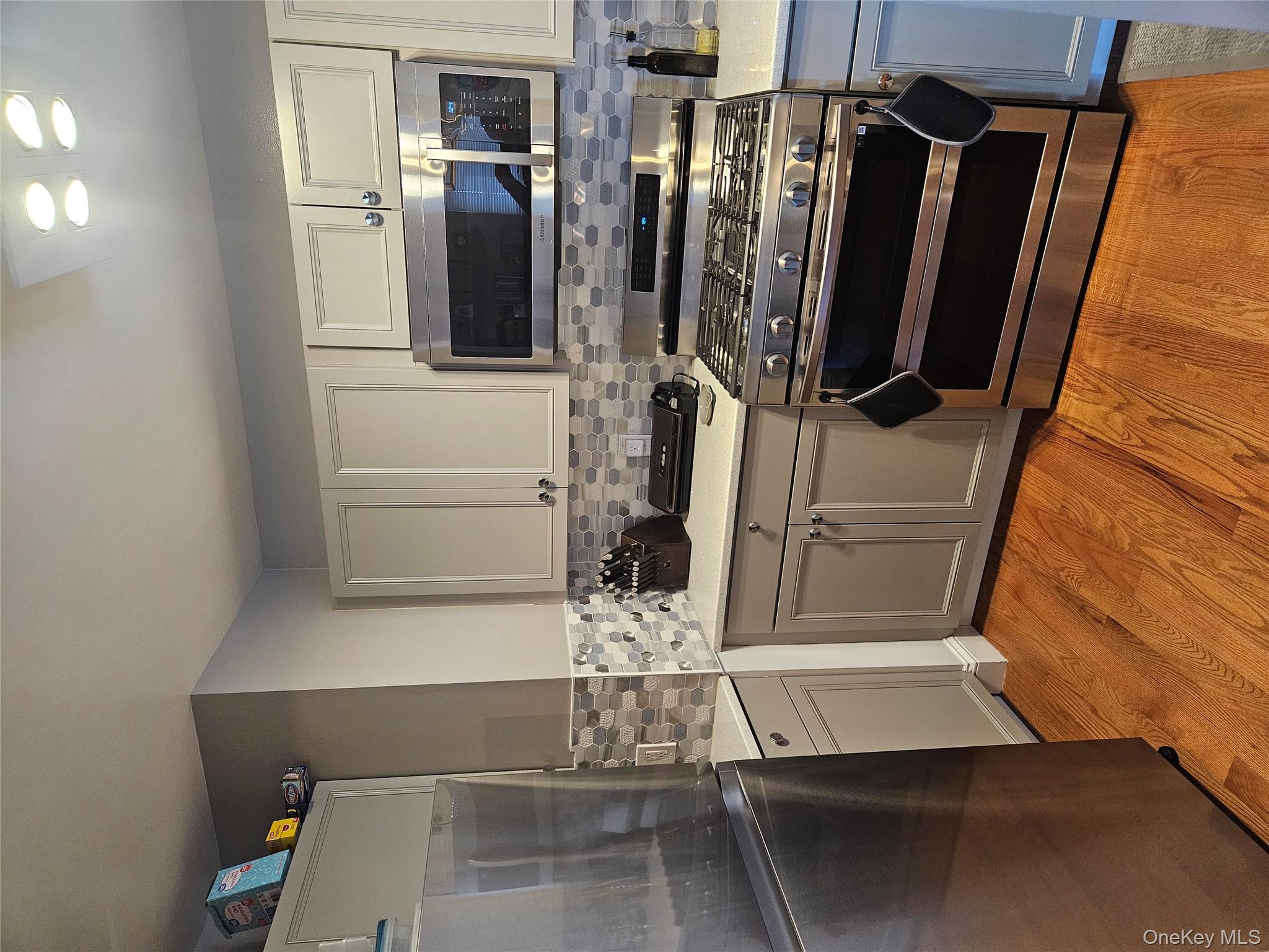 20 Lexington Hills Road, Unit 10 Harriman, NY 10926 - Photo 2 of 17 Kitchen featuring refrigerator, stove, light hardwood / wood-style floors, and tasteful backsplash