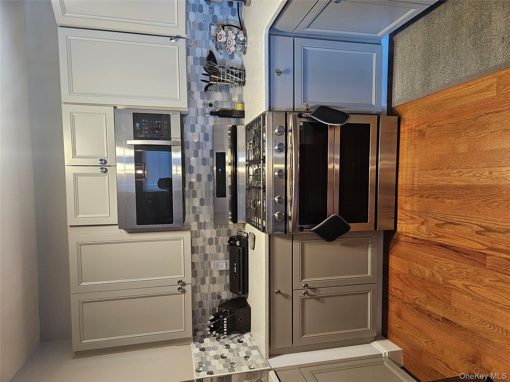 20 Lexington Hills Road, Unit 10 Harriman, NY 10926 - Photo 3 of 17 Kitchen featuring tasteful backsplash, stainless steel gas range oven, white cabinetry, and light wood-type flooring