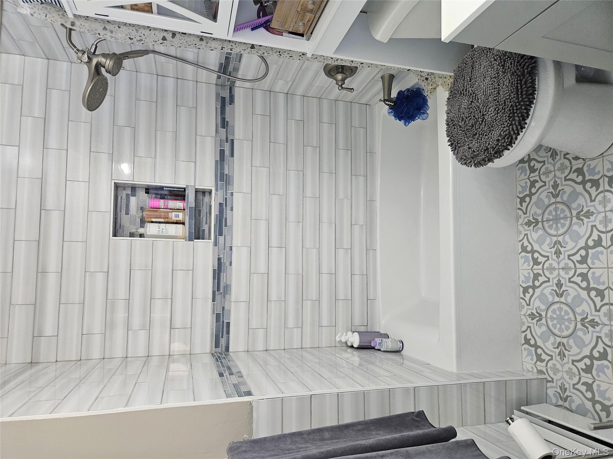 20 Lexington Hills Road, Unit 10 Harriman, NY 10926 - Photo 4 of 17 Full bathroom featuring baseboard heating, tile patterned floors, toilet, vanity, and tiled shower / bath