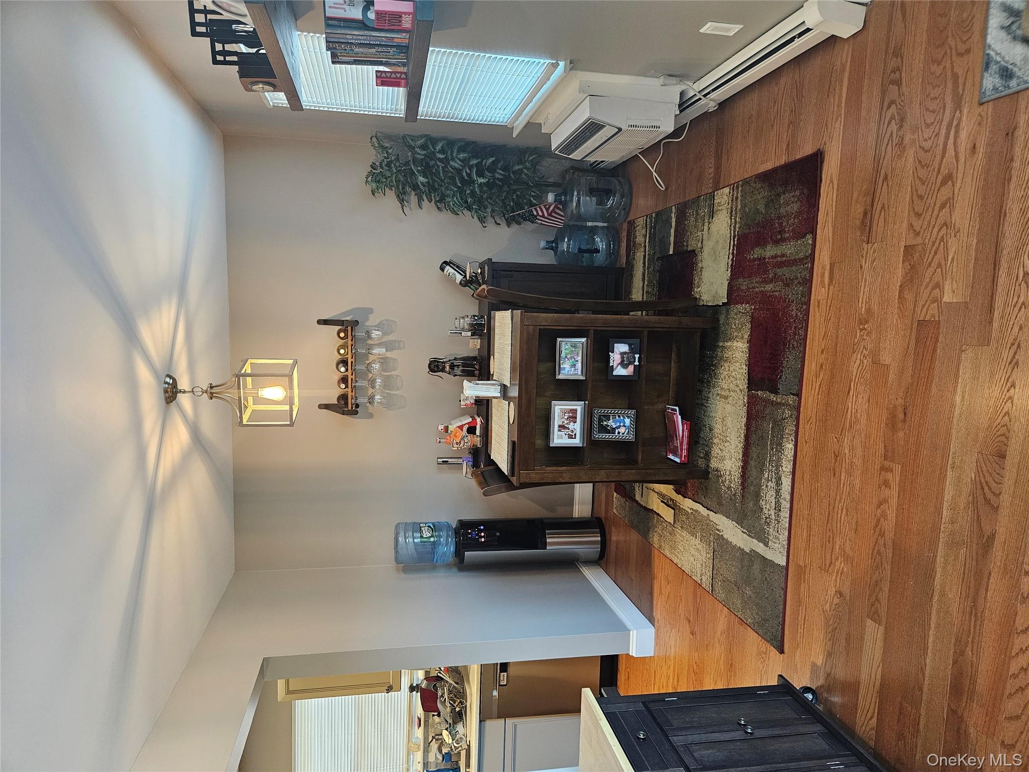 20 Lexington Hills Road, Unit 10 Harriman, NY 10926 - Photo 8 of 17 Dining area featuring wood-type flooring, a wall unit AC, and a baseboard radiator
