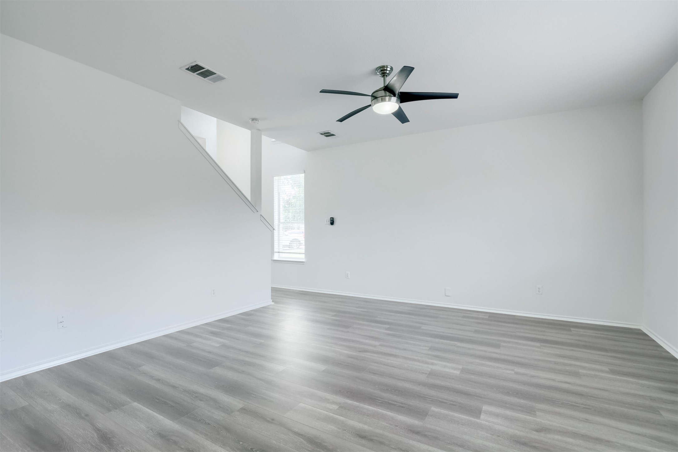 4125 Pebble Ridge Cove Round Rock, TX 78681 - Photo 14 of 30 A spacious, naturally illuminated room showcases clean lines and durable, modern flooring.