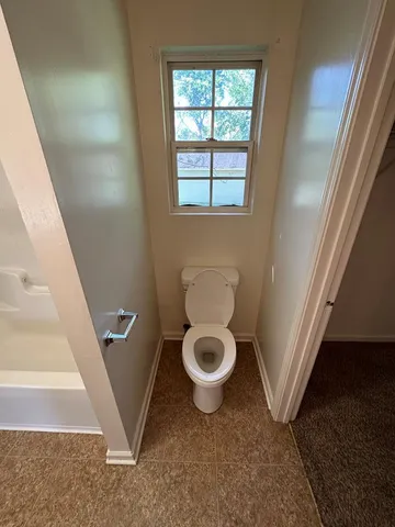 a view of a hallway with a toilet