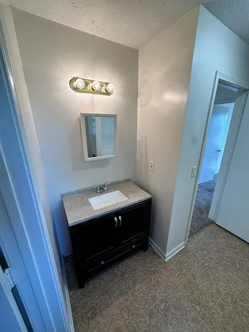 a bathroom with a sink a mirror and vanity