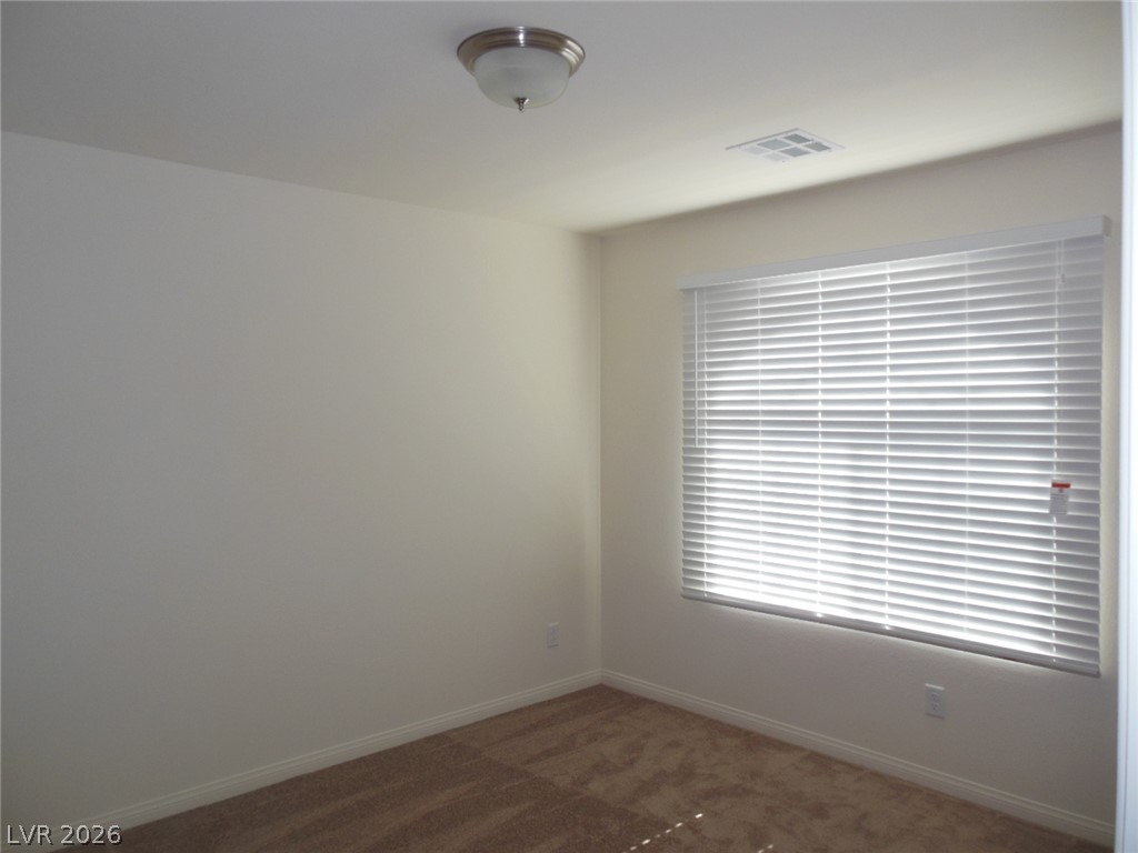 6390 Jackson Spring Road Las Vegas, NV 89118 - Photo 13 of 27 A well-lit room awaits your personal touch, offering comfort and privacy.