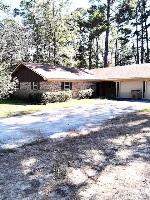 a front view of a house with a yard and trees