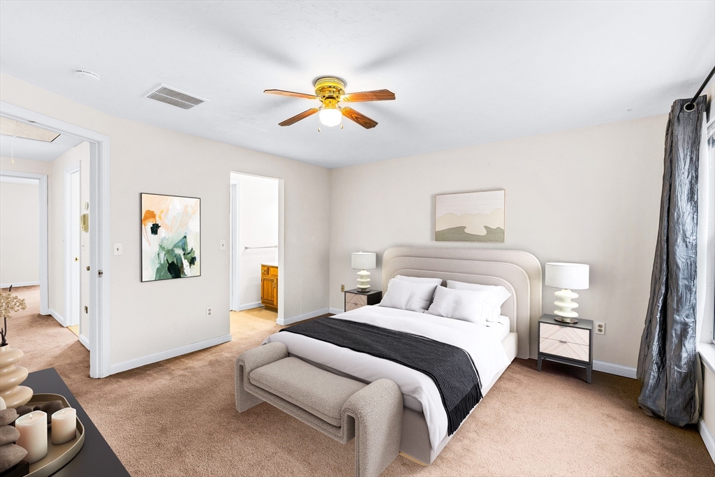 303 Ridgefield Circle, Unit B Clinton, MA 01510 - Photo 11 of 23 a bedroom with a bed and a chandelier